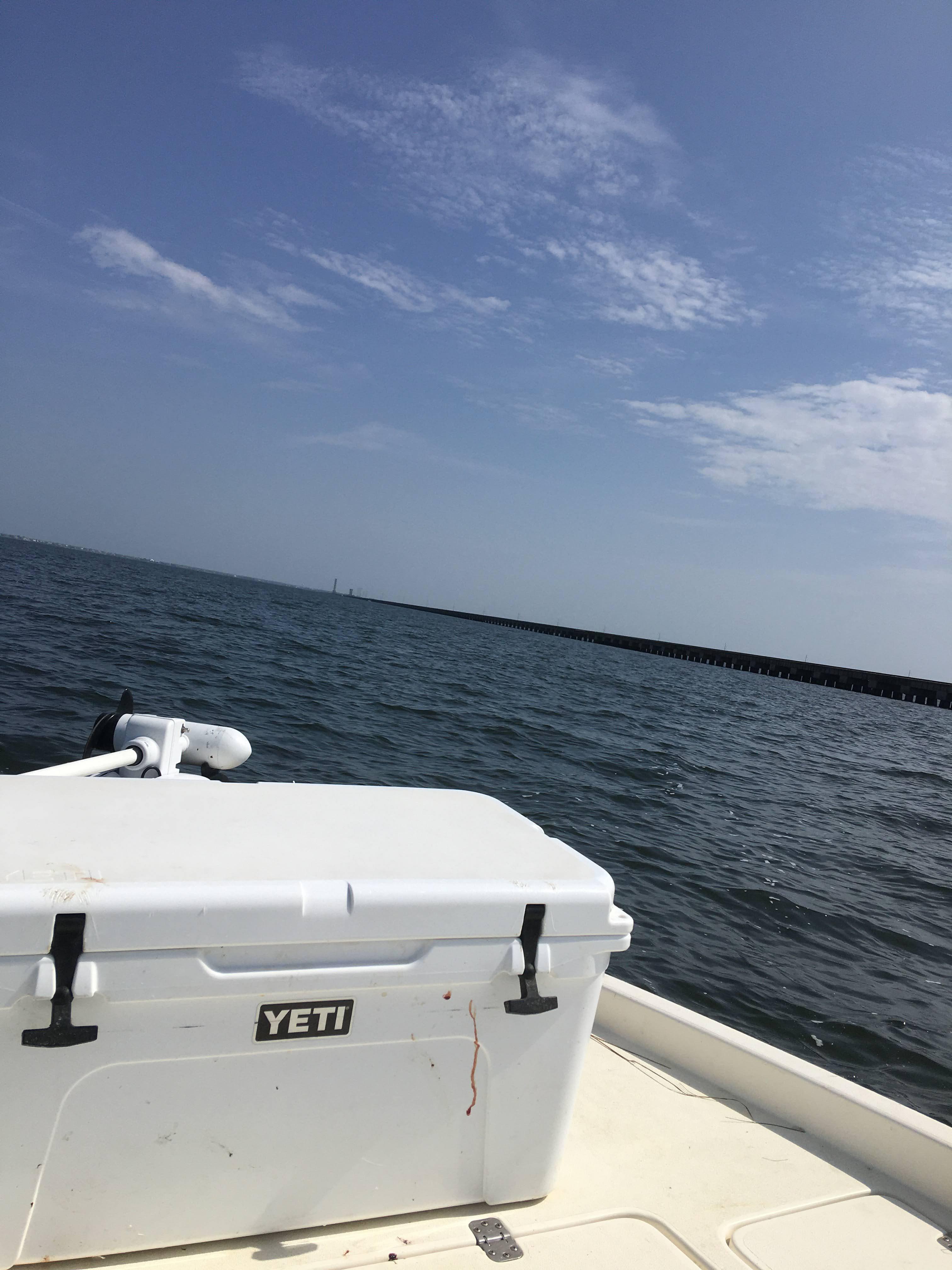 Boat deck view of open water and a long Southeast Louisiana bridge