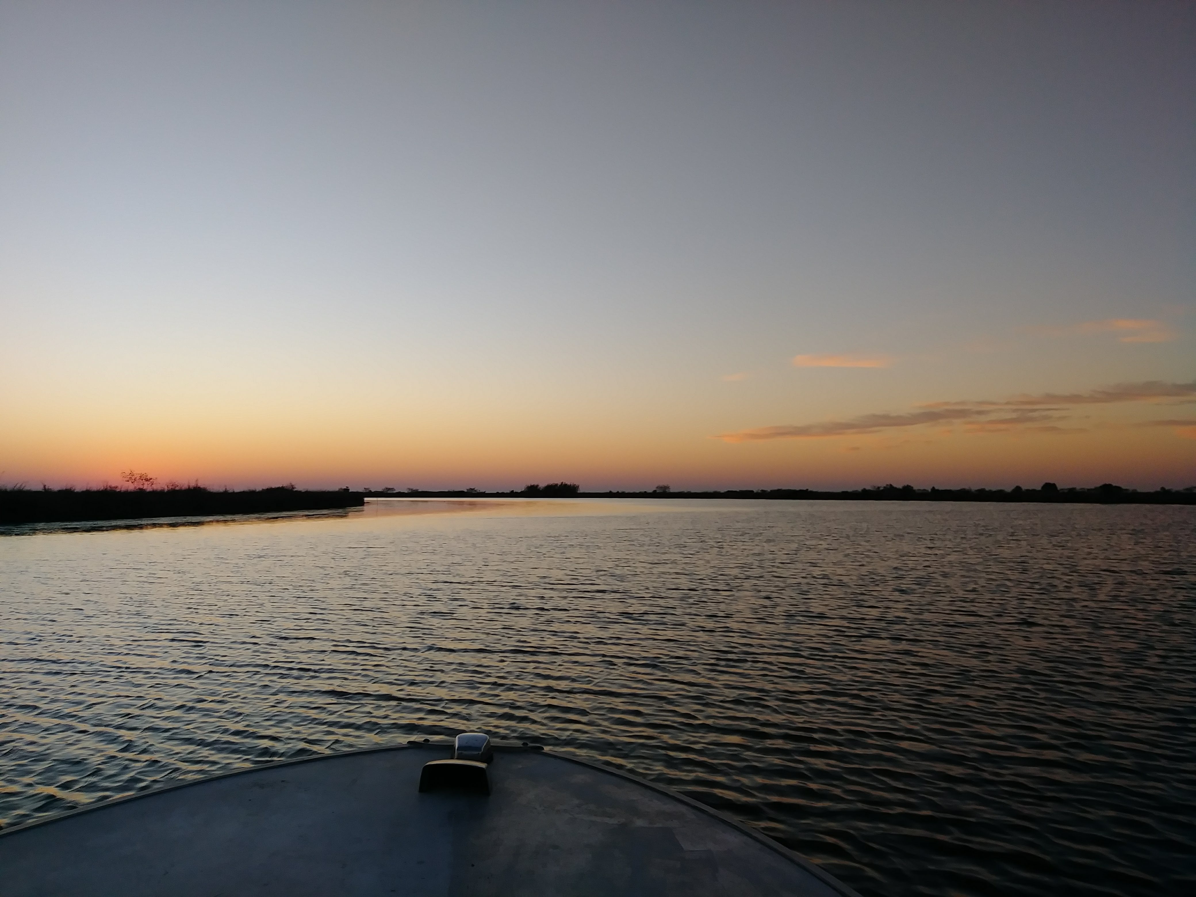 Sunset over moving marsh water in Southeast Louisiana
